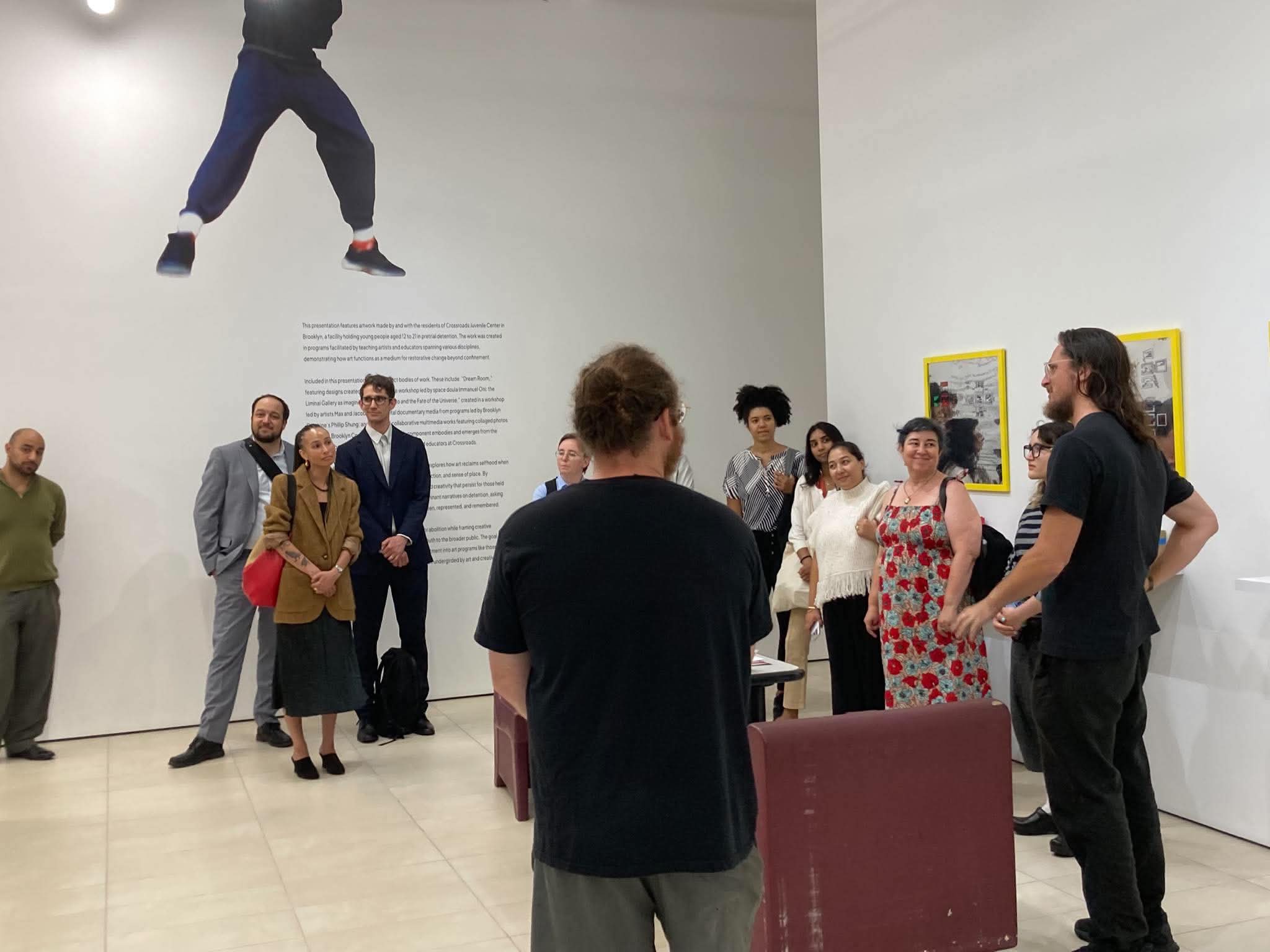 Max and Jacob Cohen talking with a delegation from the New York City Mayor's Office at the Center for Art and Advocacy, in front of work made at Crossroads Juvenile Center
